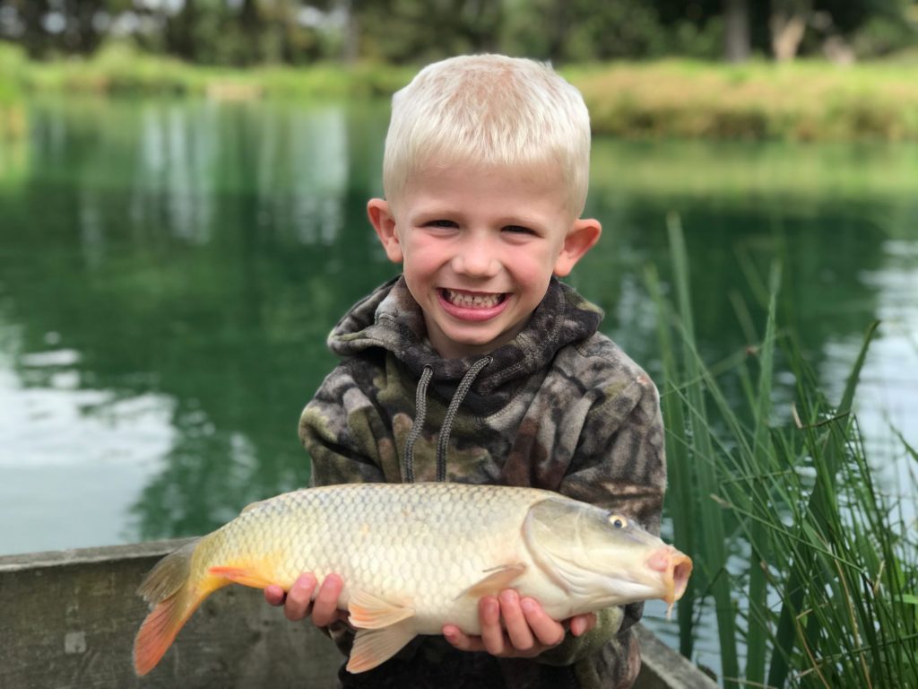 His first carp with The School of Fish